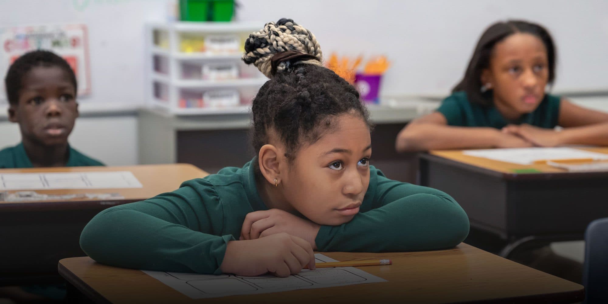 Students listening at their desks during a lesson.