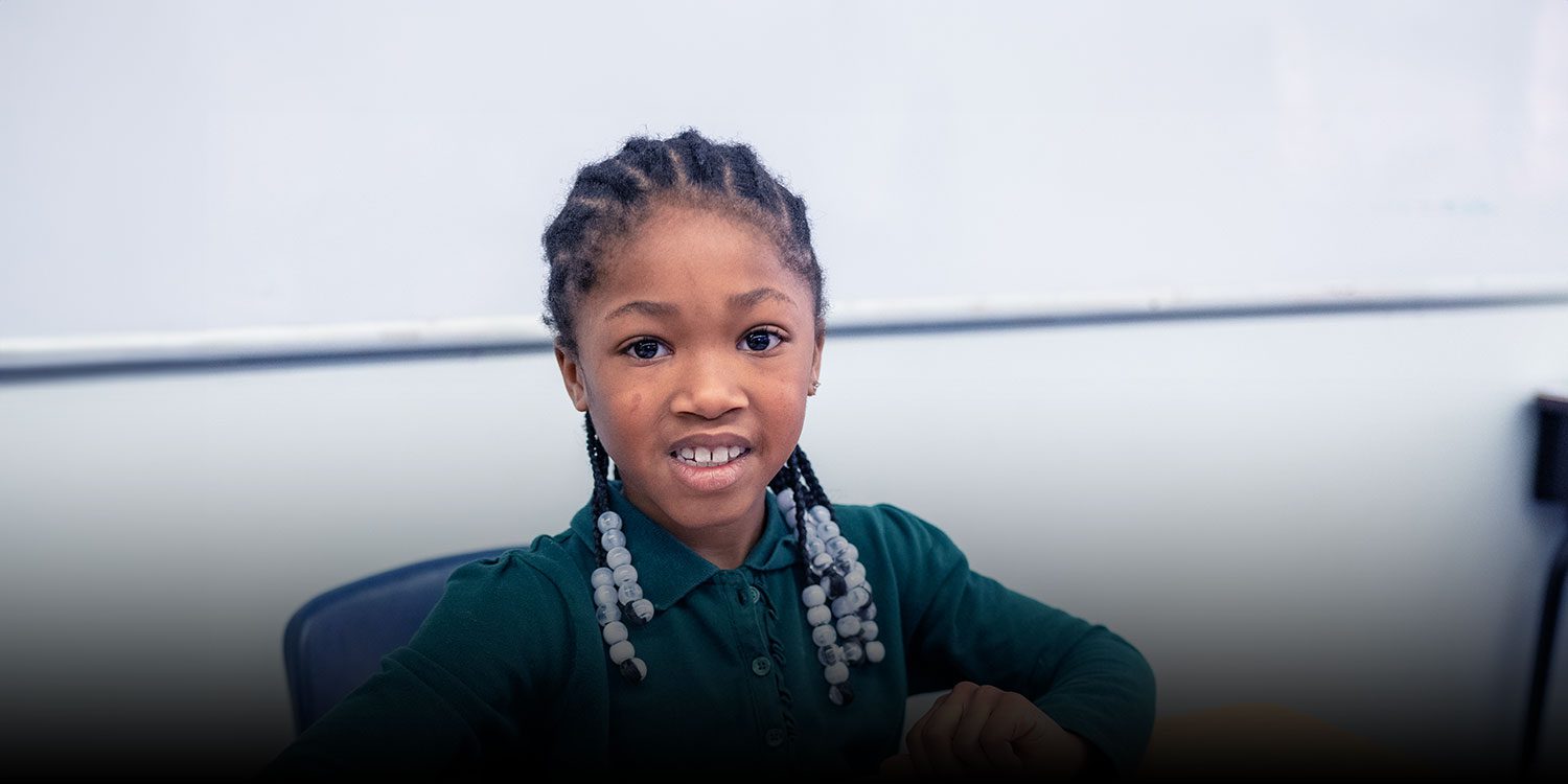 Student smiling in a classroom